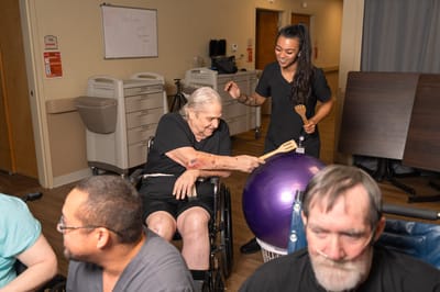 Residents participating in a recreational activity with staff