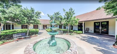 Courtyard with a fountain and greenery