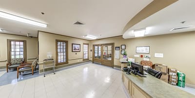 Lobby area of a senior living facility with reception desk