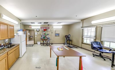 Interior view of an activity room with a table and chairs