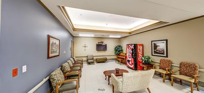 A cozy common area with seating and a vending machine
