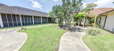Outdoor garden area with pathways and buildings