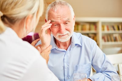Caregiver interacting with a resident at a table