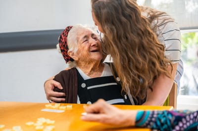 Staff member joyfully interacting with a resident