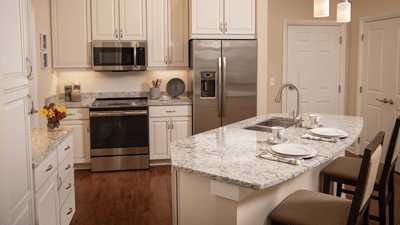 Bright, modern kitchen with granite countertop and appliances