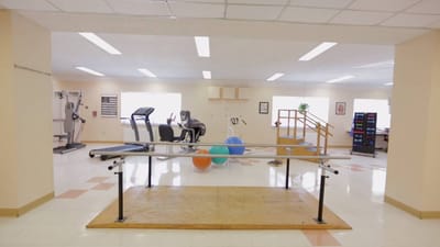 Interior view of a rehabilitation area with gym equipment