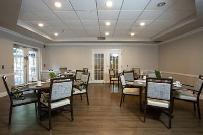 Dining area with tables and chairs set for meals