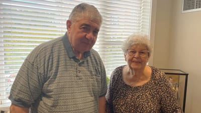 Two residents smiling in a bright interior space