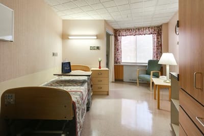 Comfortable resident room with bed and seating area