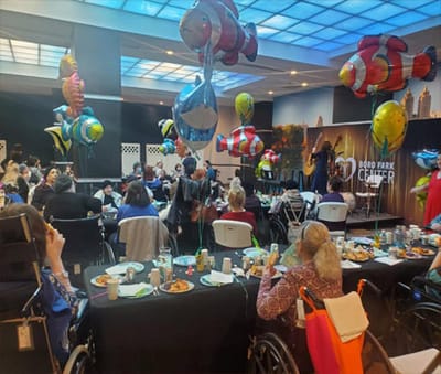Residents enjoying a lively decorated event with balloons