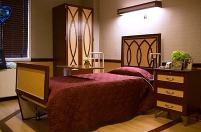 Private resident room with a bed and cabinet