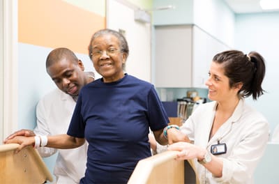 Staff assisting a resident during therapy