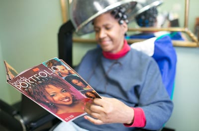 Resident enjoying a hair treatment in a salon chair