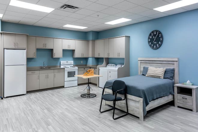 Bright interior of a resident room with kitchen area