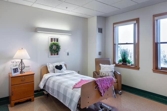 Cozy patient room with bedside lamp and decorations