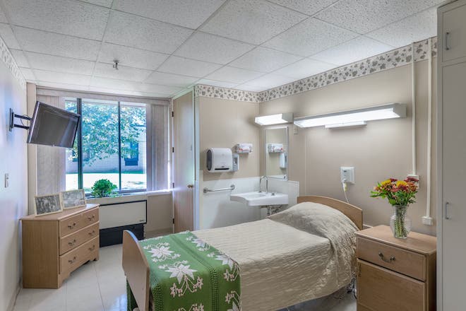 A cozy resident room with a bed and furnishings
