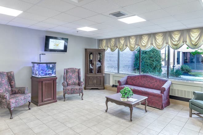 Bright and welcoming common area with seating and aquarium