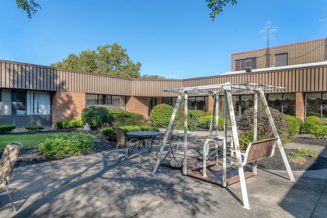 Outdoor courtyard with seating and swing set