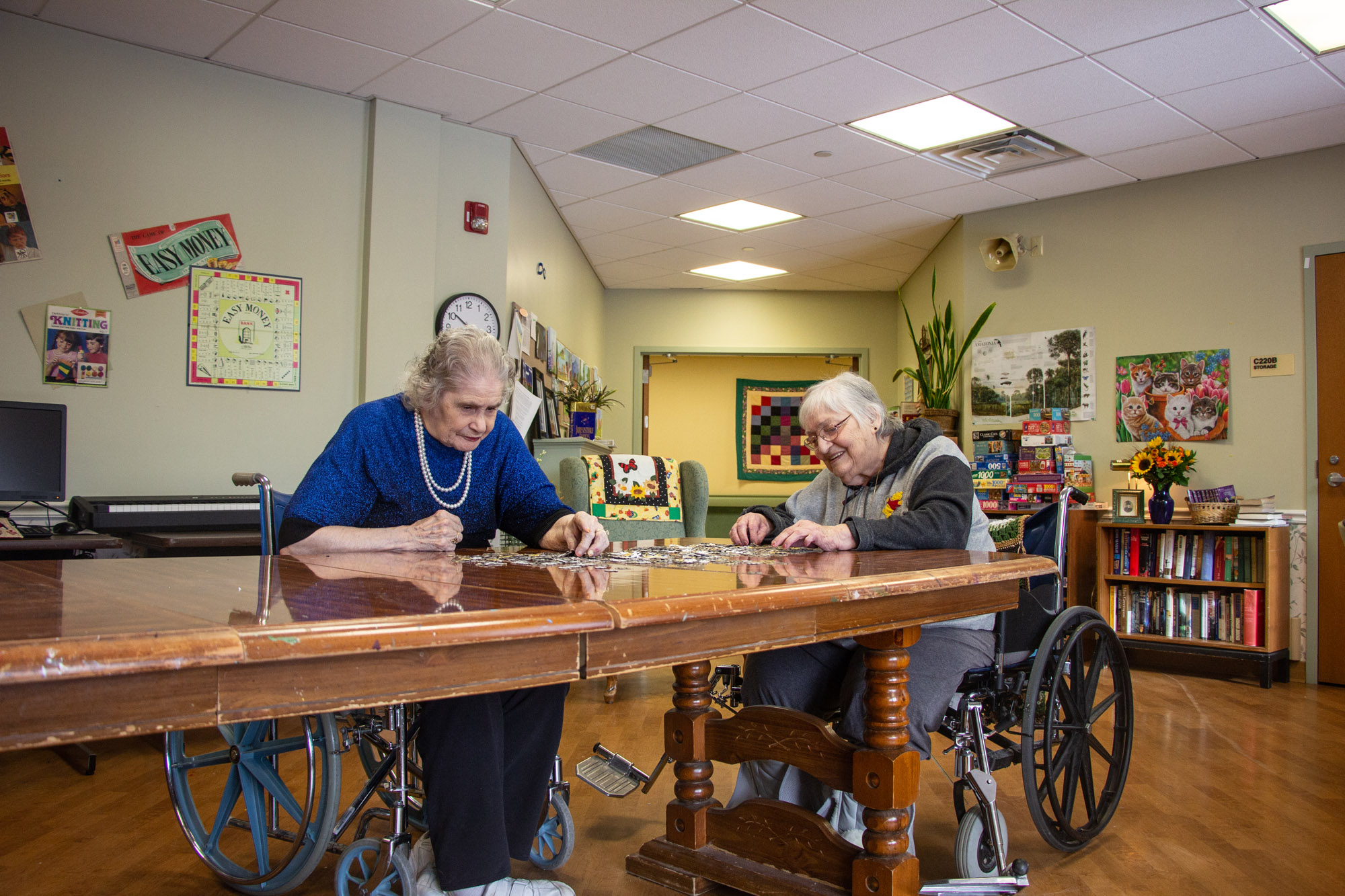 Two residents engaging in a puzzle activity at a table