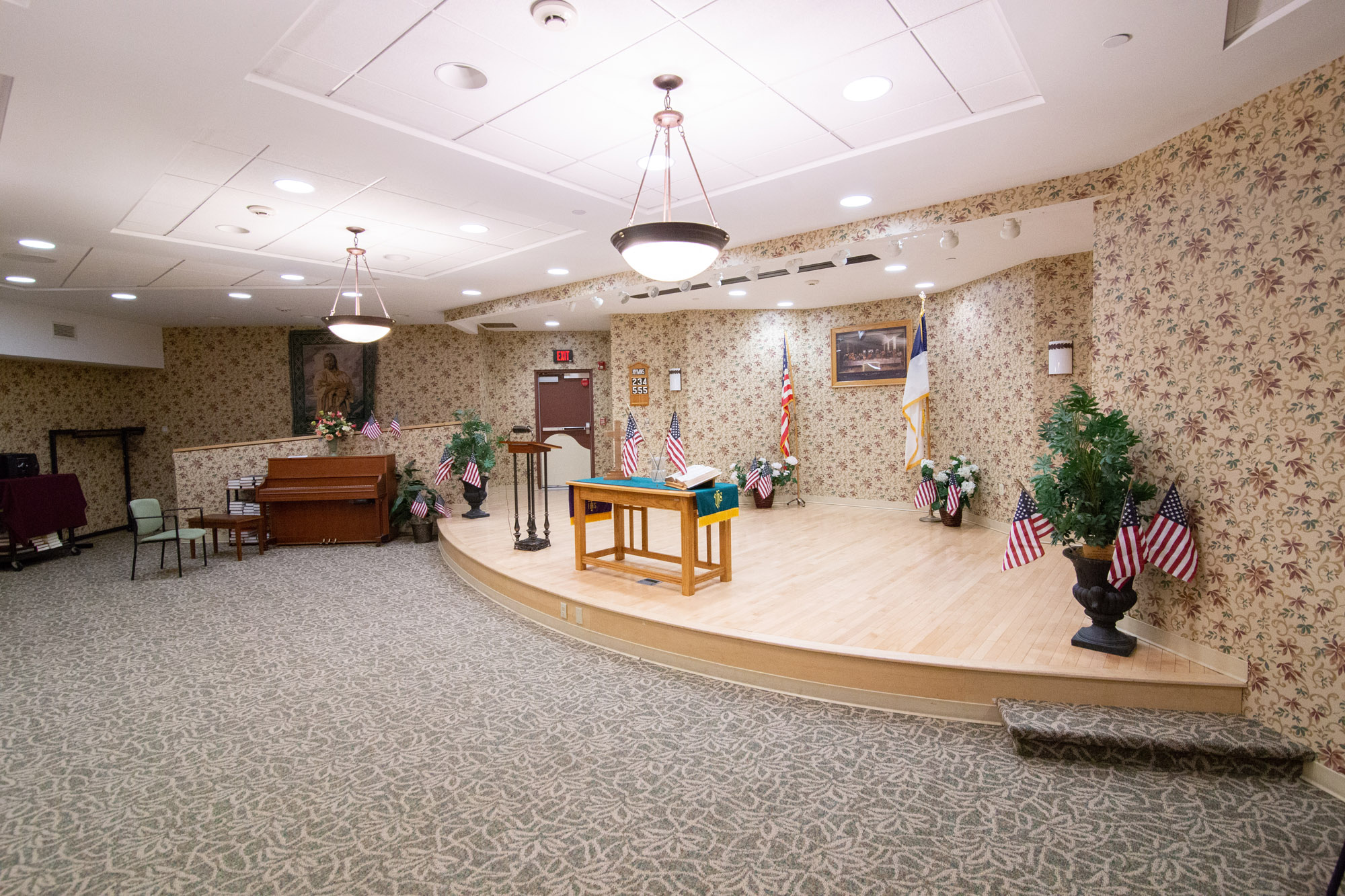 Interior view of a multi-purpose room with floral wallpaper