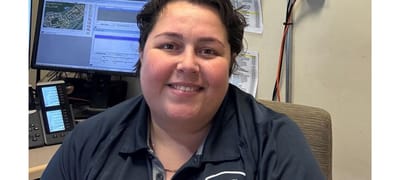 Staff member posing in an office setting