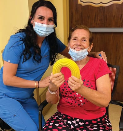 Staff member with resident engaging in activity