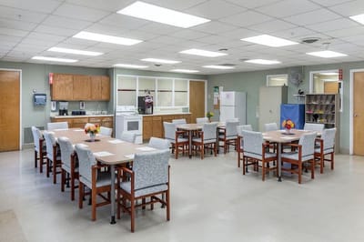 Common area with tables and chairs for residents