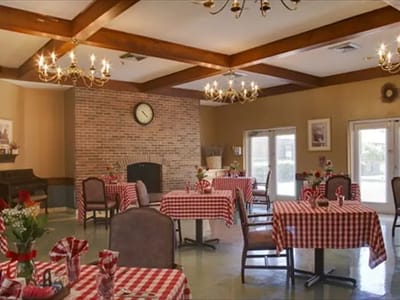 Dining area with checkered tablecloths and decorative chandeliers