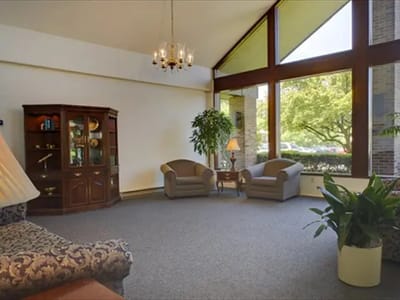 Bright common area with seating and large windows