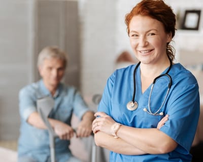 Avamere Rehabilitation of Clackamas, nursing home in Gladstone, OR — Nurse smiling in a rehabilitation facility setting