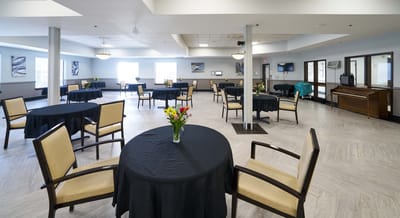 Interior of a common area with tables and flowers