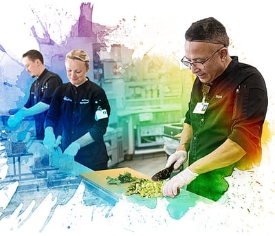 Staff preparing food in a colorful kitchen
