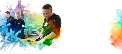 Staff preparing food in a kitchen setting