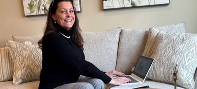 Staff member working on a laptop in a common area