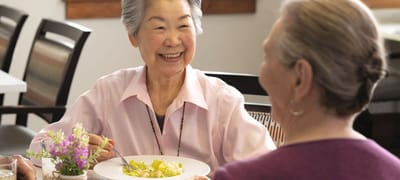 Residents enjoying a meal together in the dining room