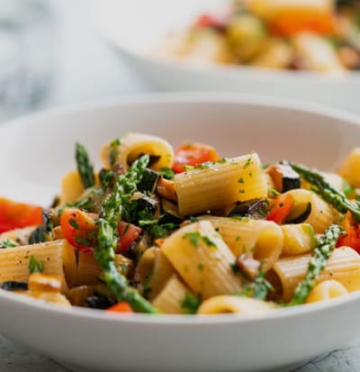 A plate of pasta with vegetables