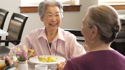 Residents enjoying a meal together in a dining room
