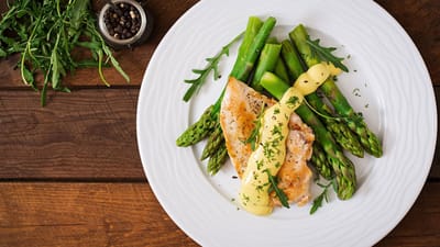 Plated fish and asparagus with sauce