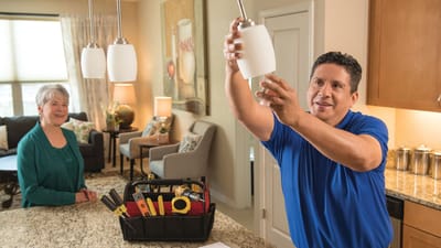 Maintenance worker assisting a resident in an apartment
