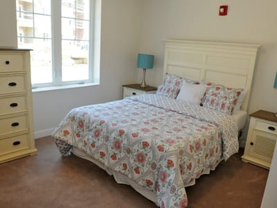 A cozy resident room with a neatly made bed