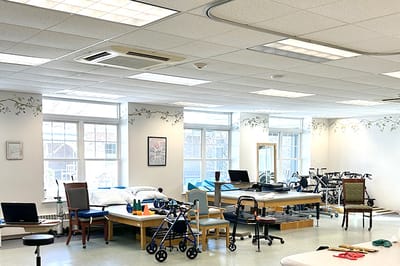 Spacious therapy room with exercise equipment and furniture