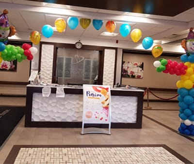 Festively decorated lobby with balloons and a welcome sign