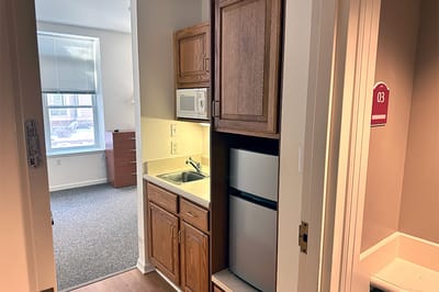 Interior view of a resident room and kitchenette