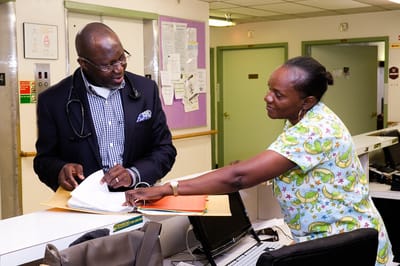 Staff member assisting a resident in the facility lobby