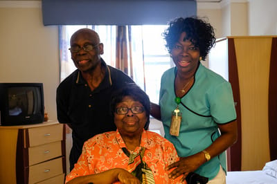 Staff and residents smiling in a cozy room