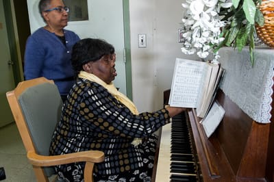 Residents engaging in music activity inside the facility