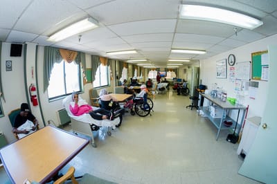 Residents in wheelchairs socializing in the common area