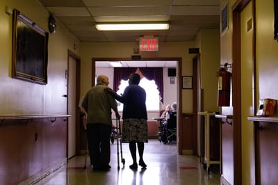 Two residents walking together in a hallway