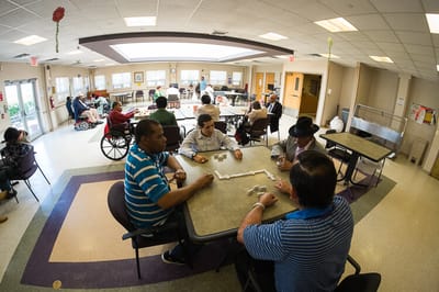 Residents enjoying a game of dominoes in a common area