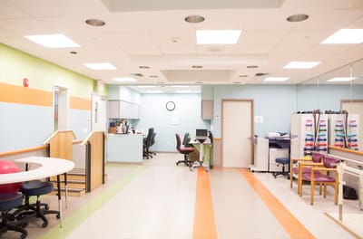 Bright therapy room with equipment and seating